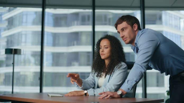 Progressive colleagues manipulating invisible display at office. Future reality