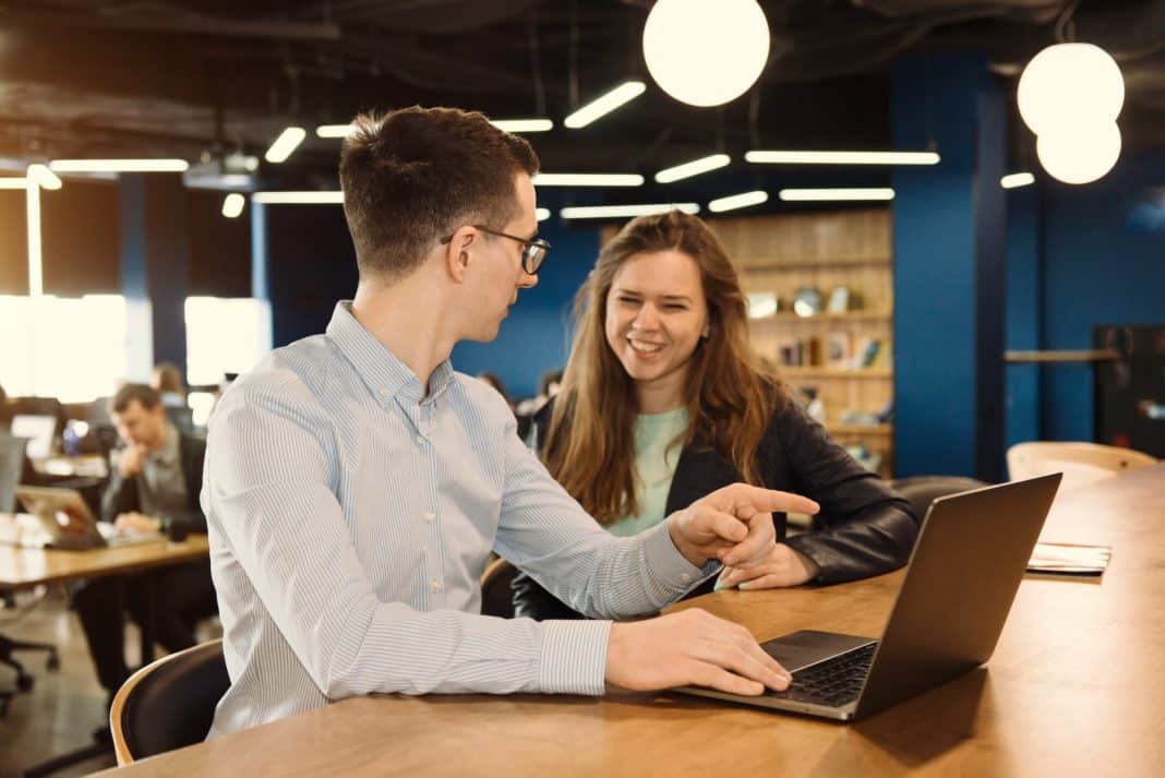 Two people working at the office. Client and manager discussing the task in co-working