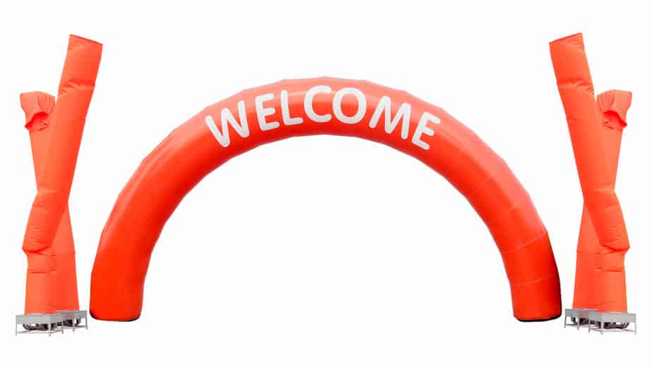 orange curve balloon with white text WELCOME and fan blowing bal