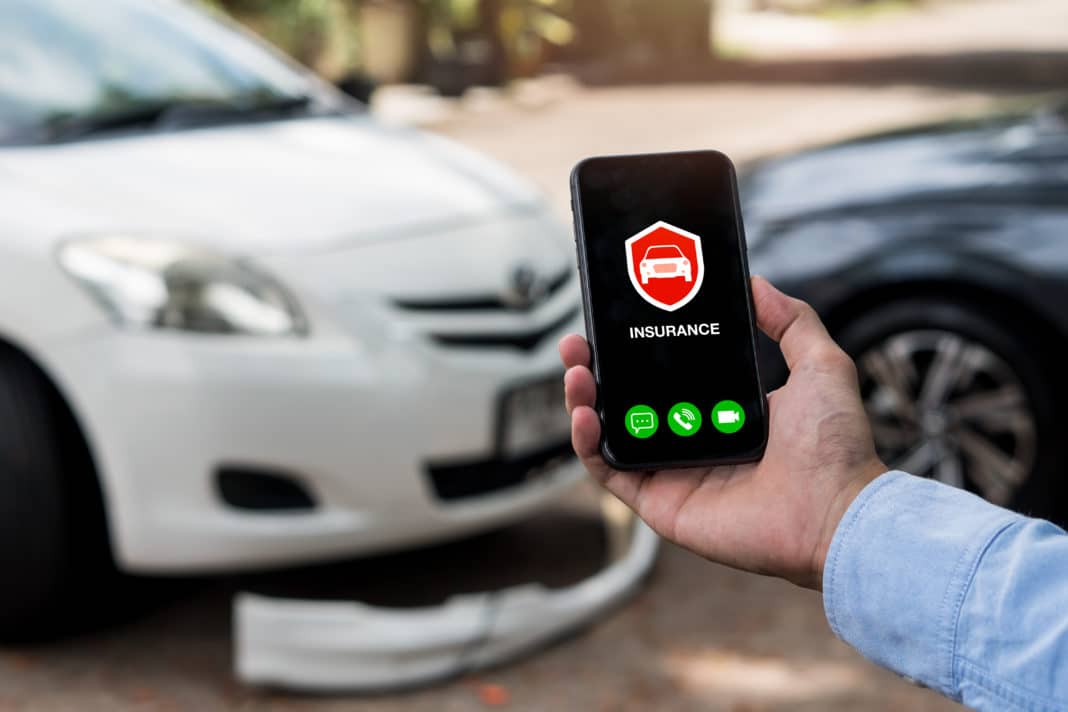 Car insurance concept.Man using phone to calling insurance agent for claim process after car crash.